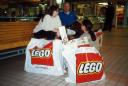 Jenn, Ken, and Rice with big bags with the red LEGO&reg; logo.
