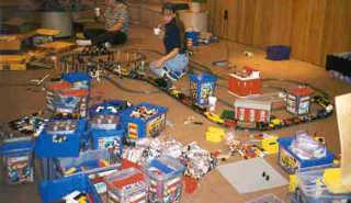 Jenn and Denise sits amongst a sea of blue tubs and track layout.